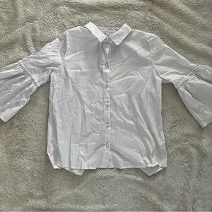 White blouse pearl button detail frilly sleeves